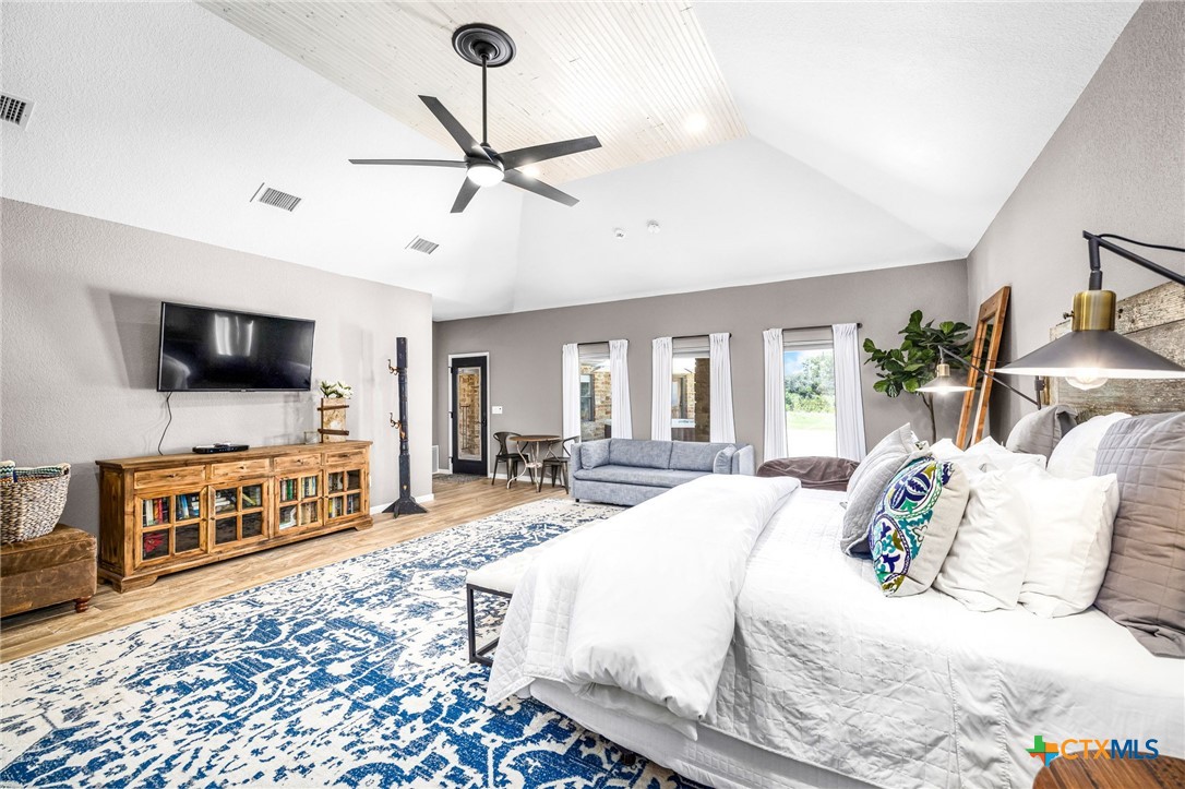 871 Chimney Valley Road Blanco, TX 78606 - Photo 24 of 45 a bedroom with furniture and a flat screen tv