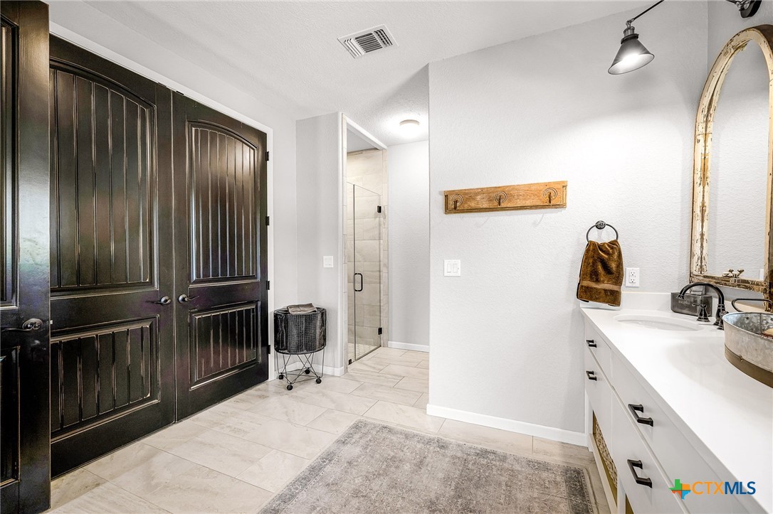 871 Chimney Valley Road Blanco, TX 78606 - Photo 26 of 45 a bathroom with a sink and a mirror