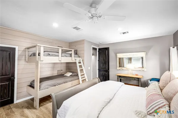 a bedroom with a bed and a with a flat tv screen