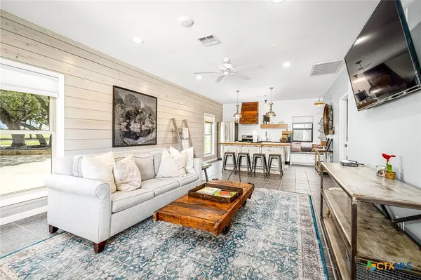 a living room with furniture and a flat screen tv
