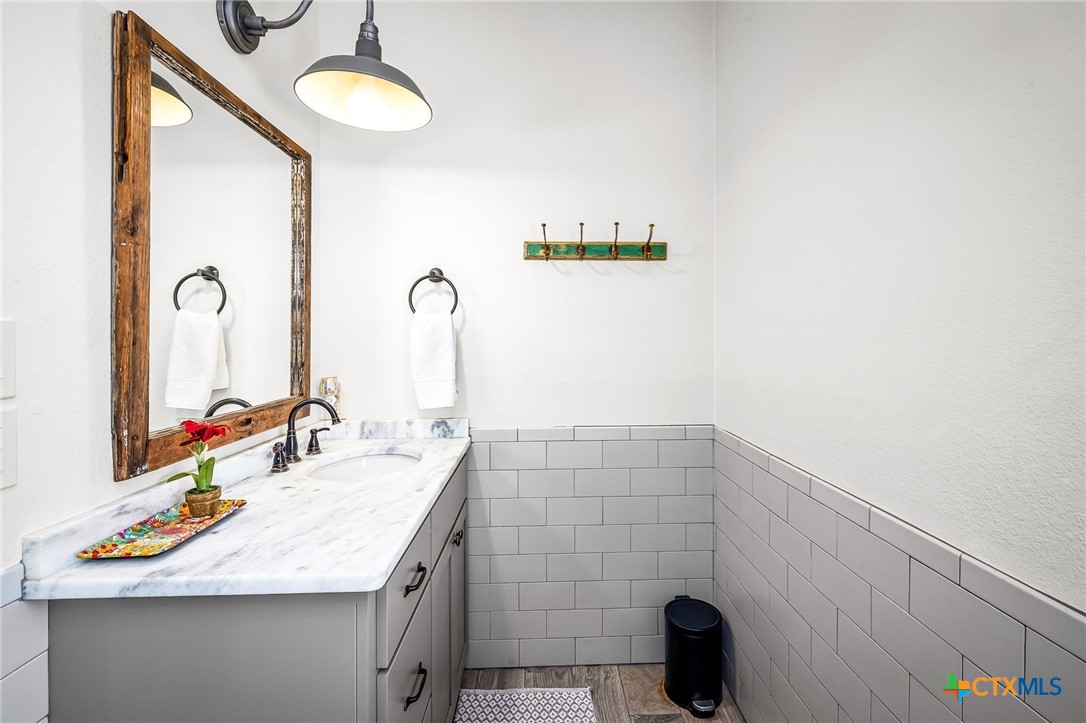 871 Chimney Valley Road Blanco, TX 78606 - Photo 39 of 45 a bathroom with a sink and a mirror