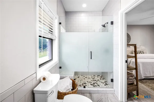 a bathroom with a bathtub and shower