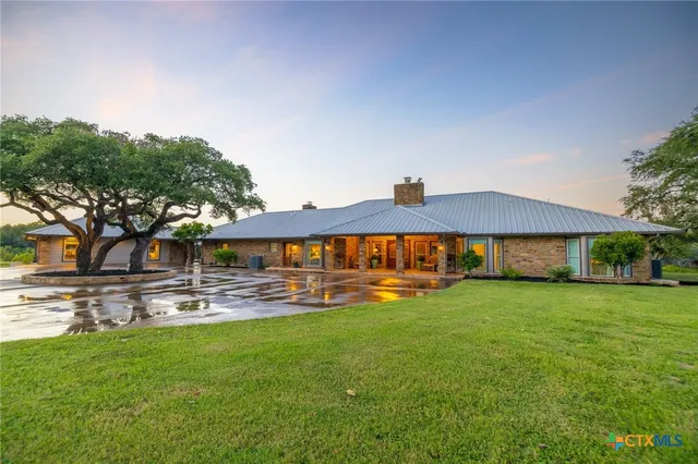 a view of a house with swimming pool and yard
