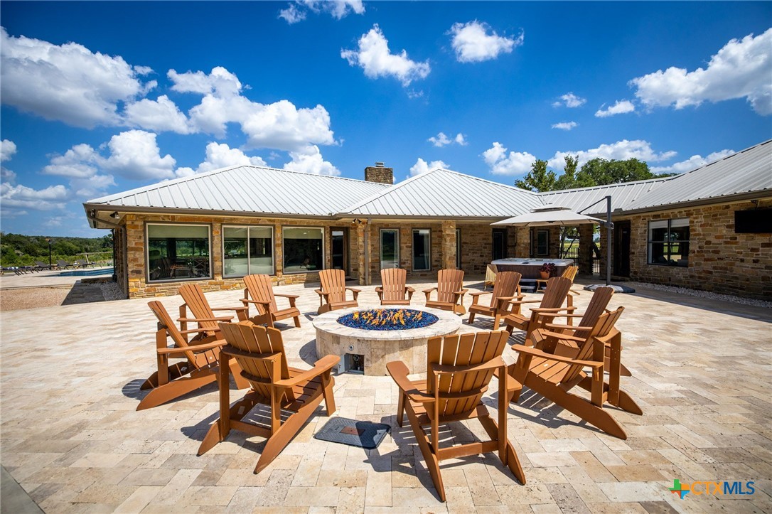 871 Chimney Valley Road Blanco, TX 78606 - Photo 42 of 45 a view of a patio with dining table and chairs with a barbeque grill and plants