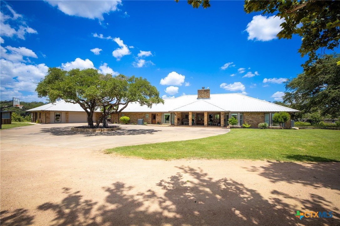 871 Chimney Valley Road Blanco, TX 78606 - Photo 5 of 45 a view of a house with swimming pool and yard