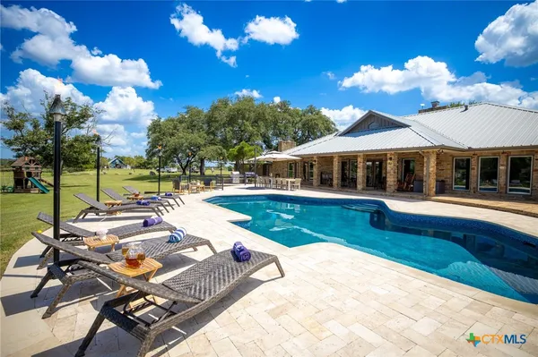 a view of swimming pool with lounge chair