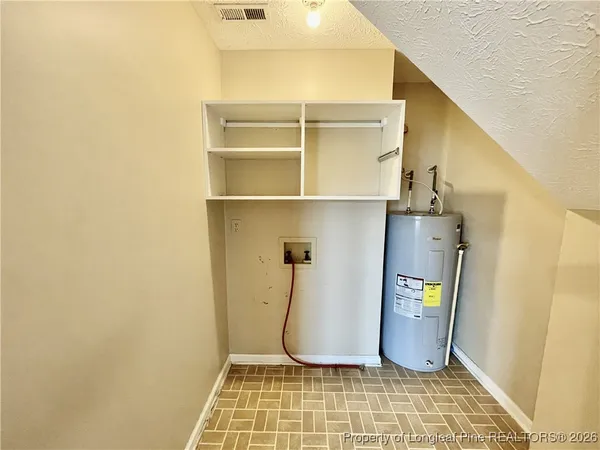 an empty room with a window and a ceiling fan