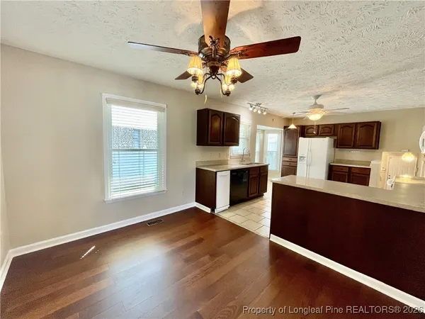 a view of a kitchen with microwave and cabinets