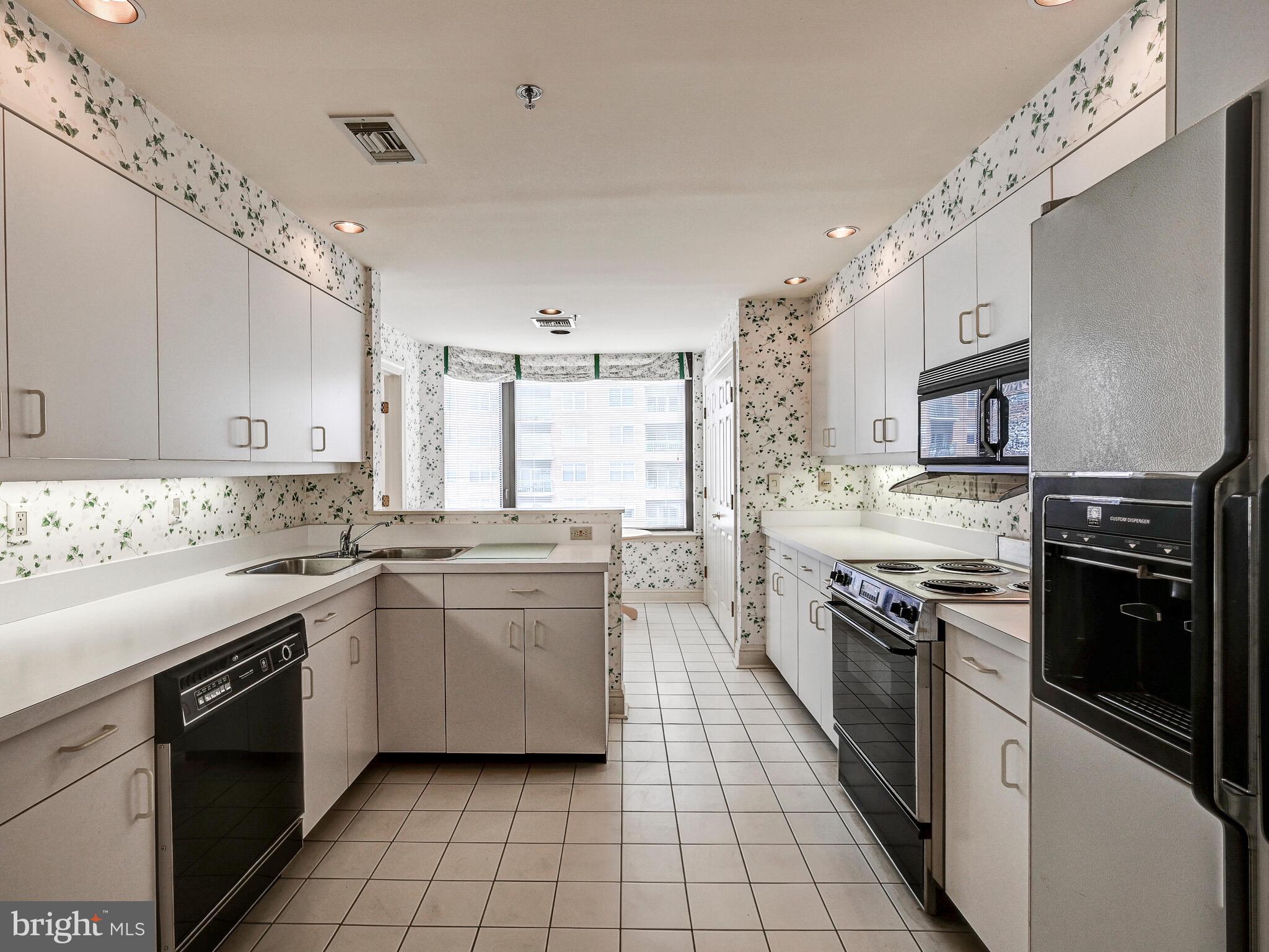 3704 North Charles Street, Unit 505 Baltimore, MD 21218 - Photo 12 of 34 a kitchen with stainless steel appliances granite countertop a sink and stove top oven