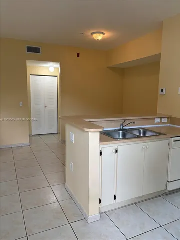 a view of a kitchen with granite countertop cabinets
