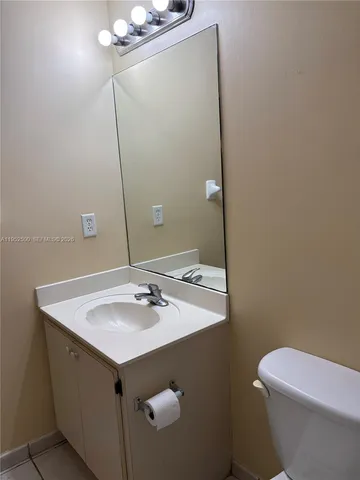 a white toilet sitting next to a bath tub