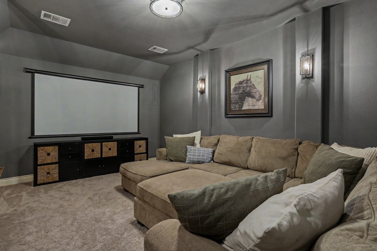 809 Prairie Dunes Drive Georgetown, TX 78628 - Photo 26 of 40 Indulge in cinematic experiences within this cozy media room, complete with a large projection screen.