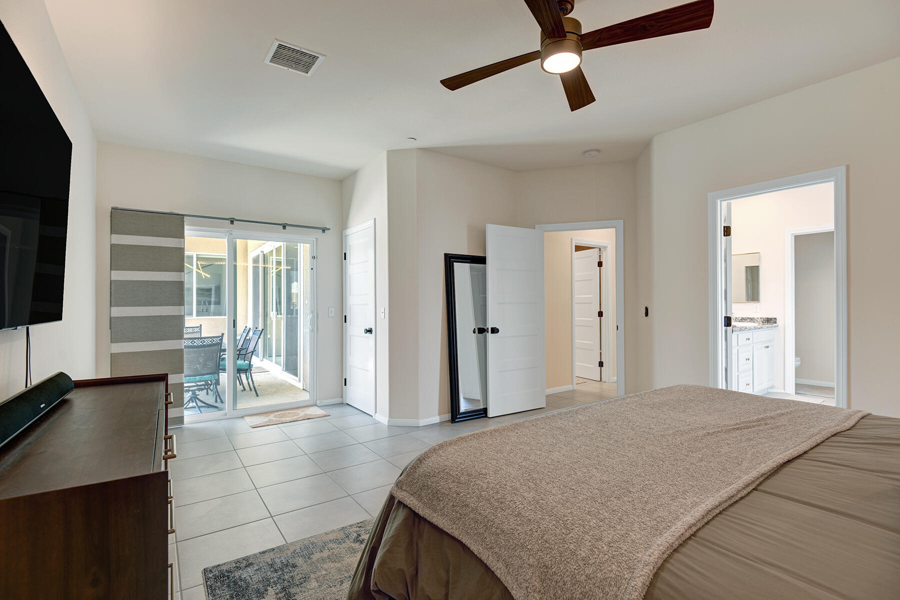68965 Hermosillo Road Cathedral City, CA 92234 - Photo 13 of 40 a bedroom with a bed and glass windows