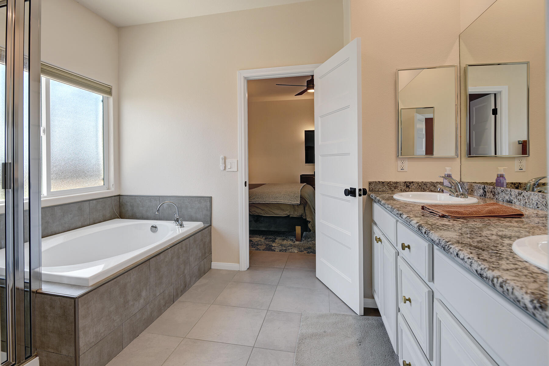 68965 Hermosillo Road Cathedral City, CA 92234 - Photo 16 of 40 a bathroom with a granite countertop tub sink and mirror