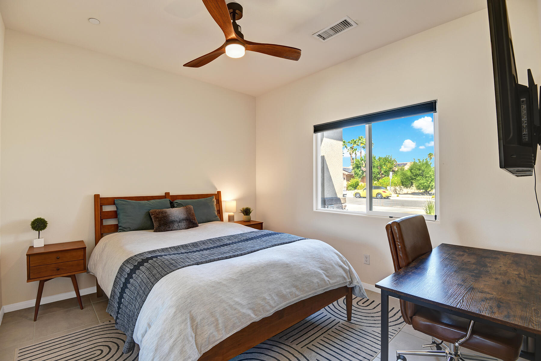 68965 Hermosillo Road Cathedral City, CA 92234 - Photo 17 of 40 a bedroom with a bed a desk and chair with wooden floor