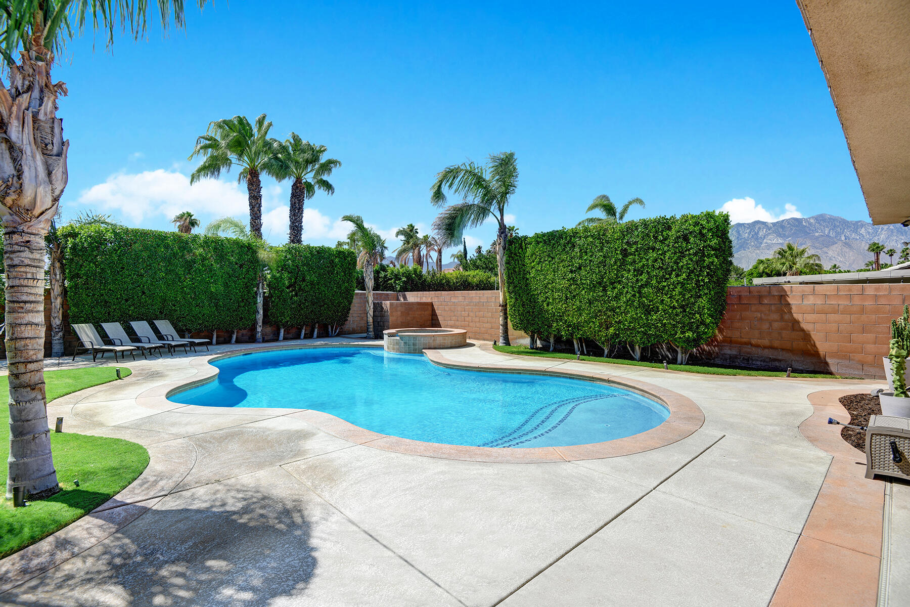 68965 Hermosillo Road Cathedral City, CA 92234 - Photo 27 of 40 a view of swimming pool with seating area and trees in the background