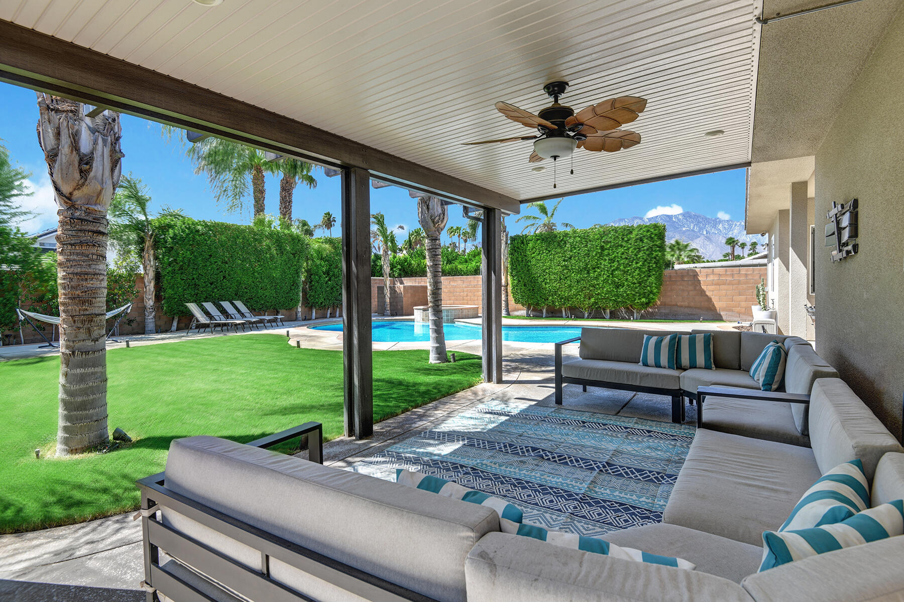 68965 Hermosillo Road Cathedral City, CA 92234 - Photo 29 of 40 a view of a patio with couches potted plants and a big yard