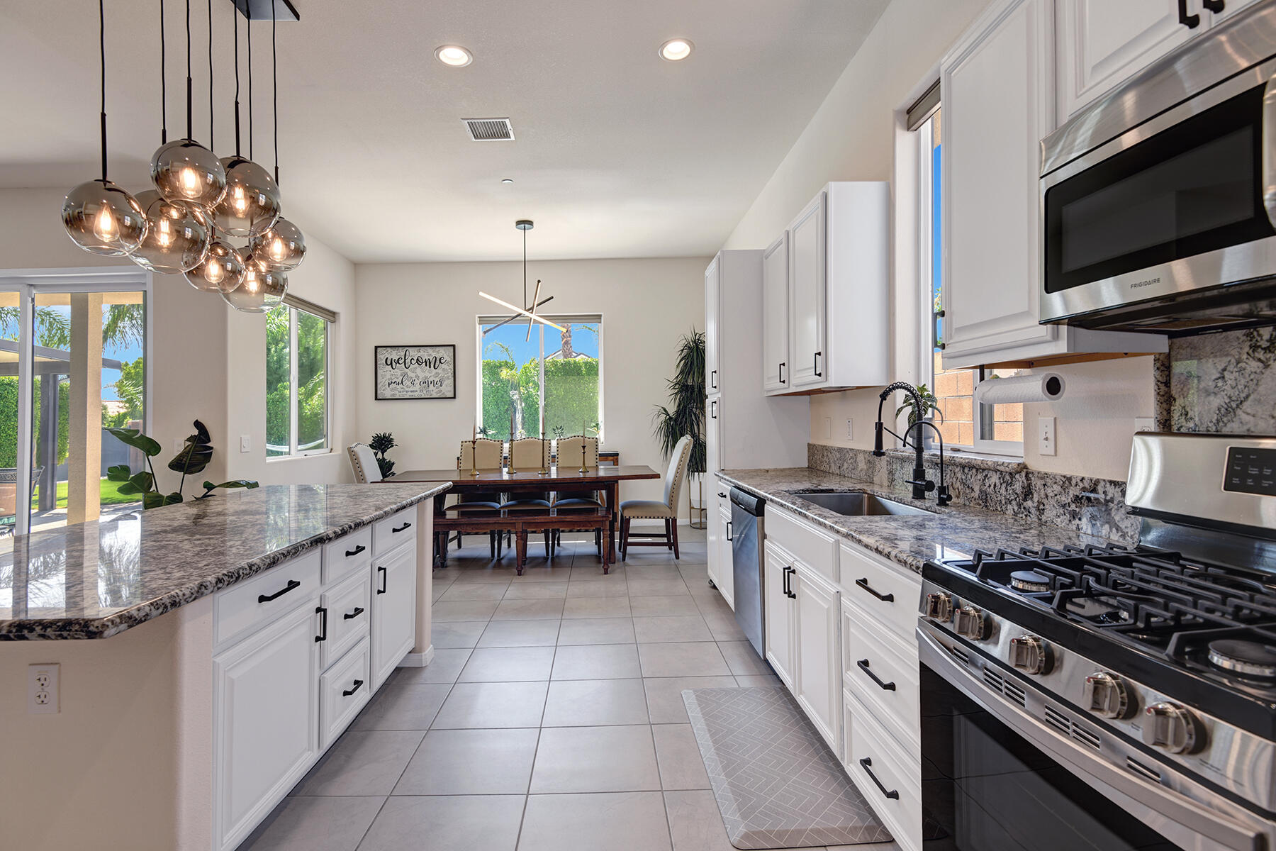 68965 Hermosillo Road Cathedral City, CA 92234 - Photo 6 of 40 a kitchen with stainless steel appliances a sink stove and microwave