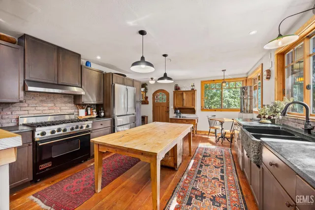 a kitchen with stainless steel appliances granite countertop a stove oven and a sink with granite countertops