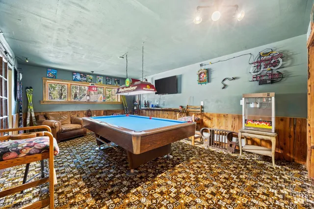a living room with furniture a rug and a painting on the wall