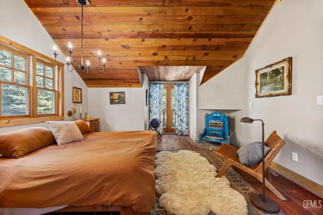 a bedroom with a bed and a chandelier