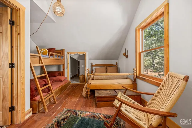 a bedroom with furniture and a wooden floor