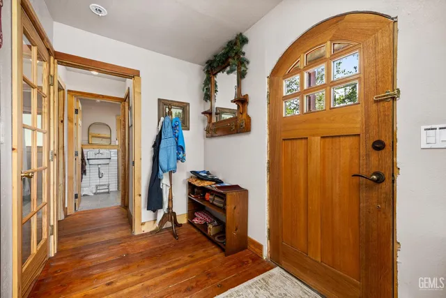 a view of an entryway with wooden floor and a livingroom