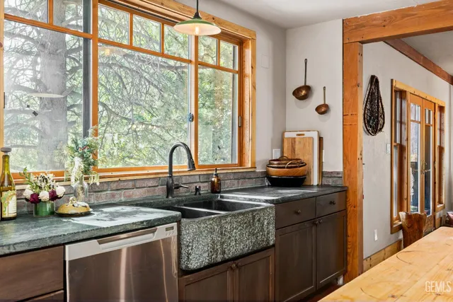 a kitchen with granite countertop a sink and a window