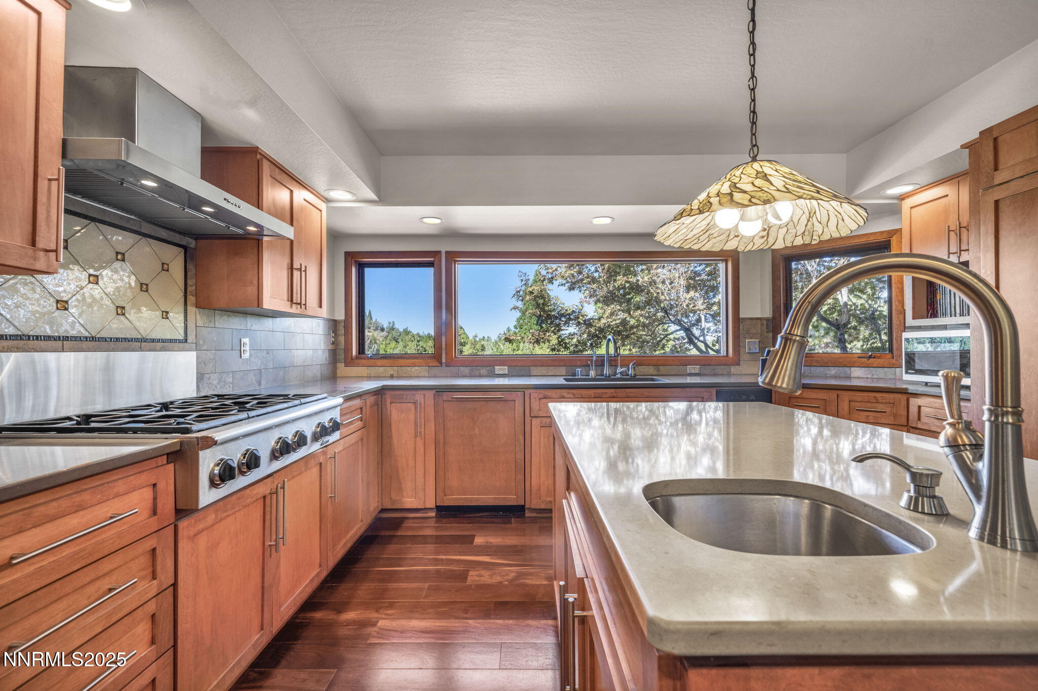 4283 Water Hole Road Reno, NV 89519 - Photo 17 of 62 a kitchen with granite countertop a stove and a sink