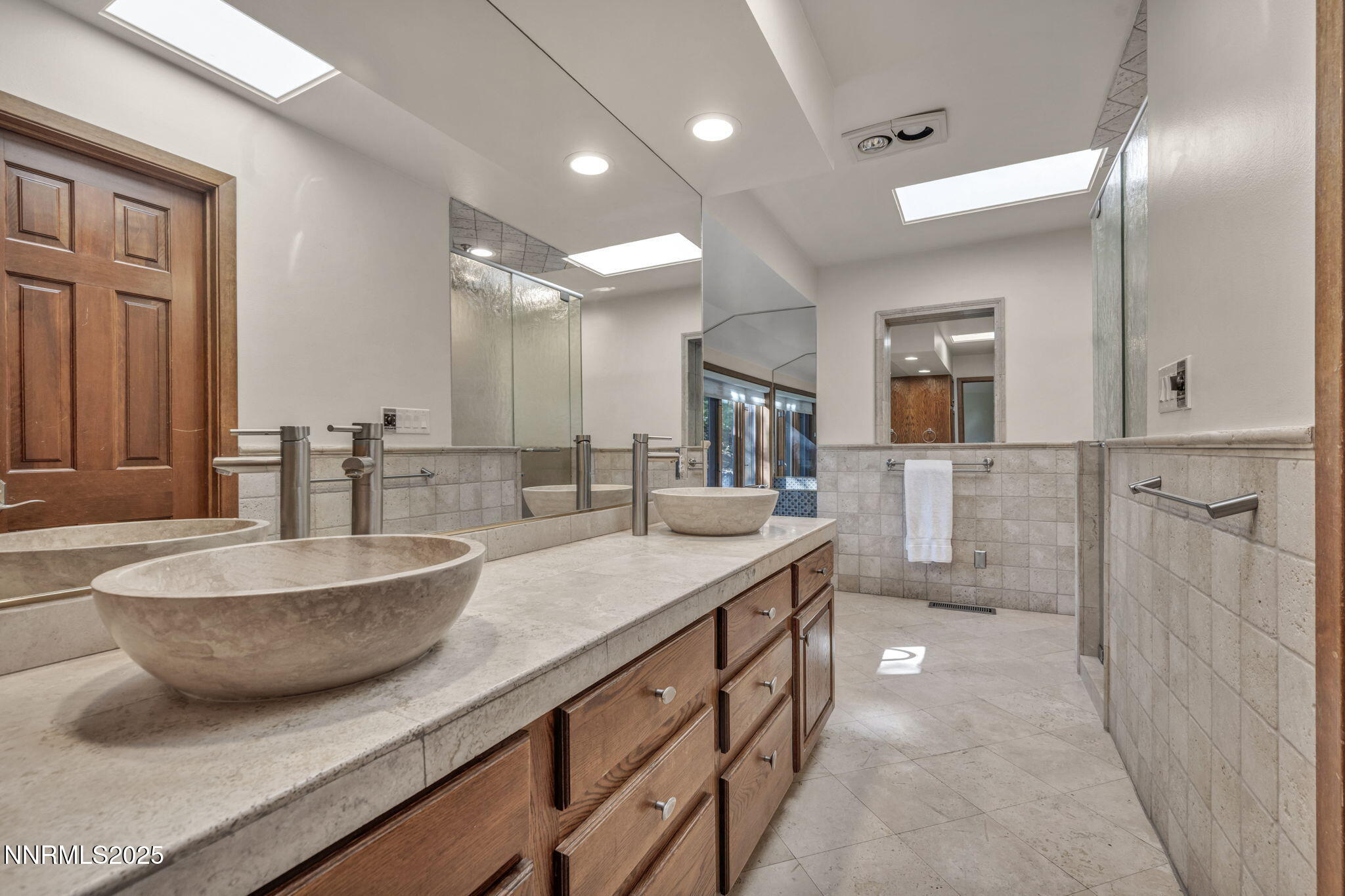 4283 Water Hole Road Reno, NV 89519 - Photo 28 of 62 a bathroom with a granite countertop sink a toilet a mirror and bathtub