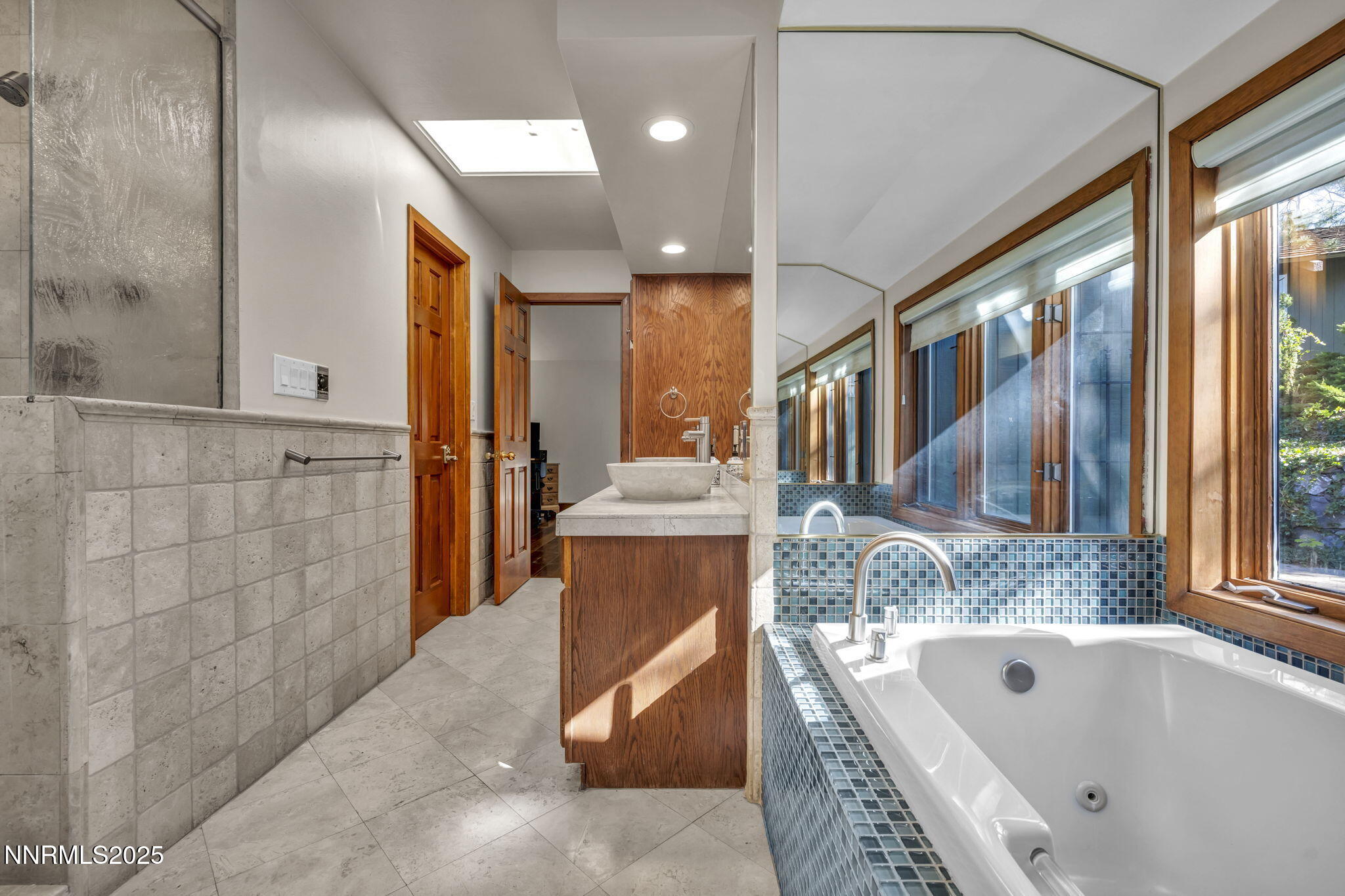 4283 Water Hole Road Reno, NV 89519 - Photo 29 of 62 a bathroom with a tub a sink and a large window