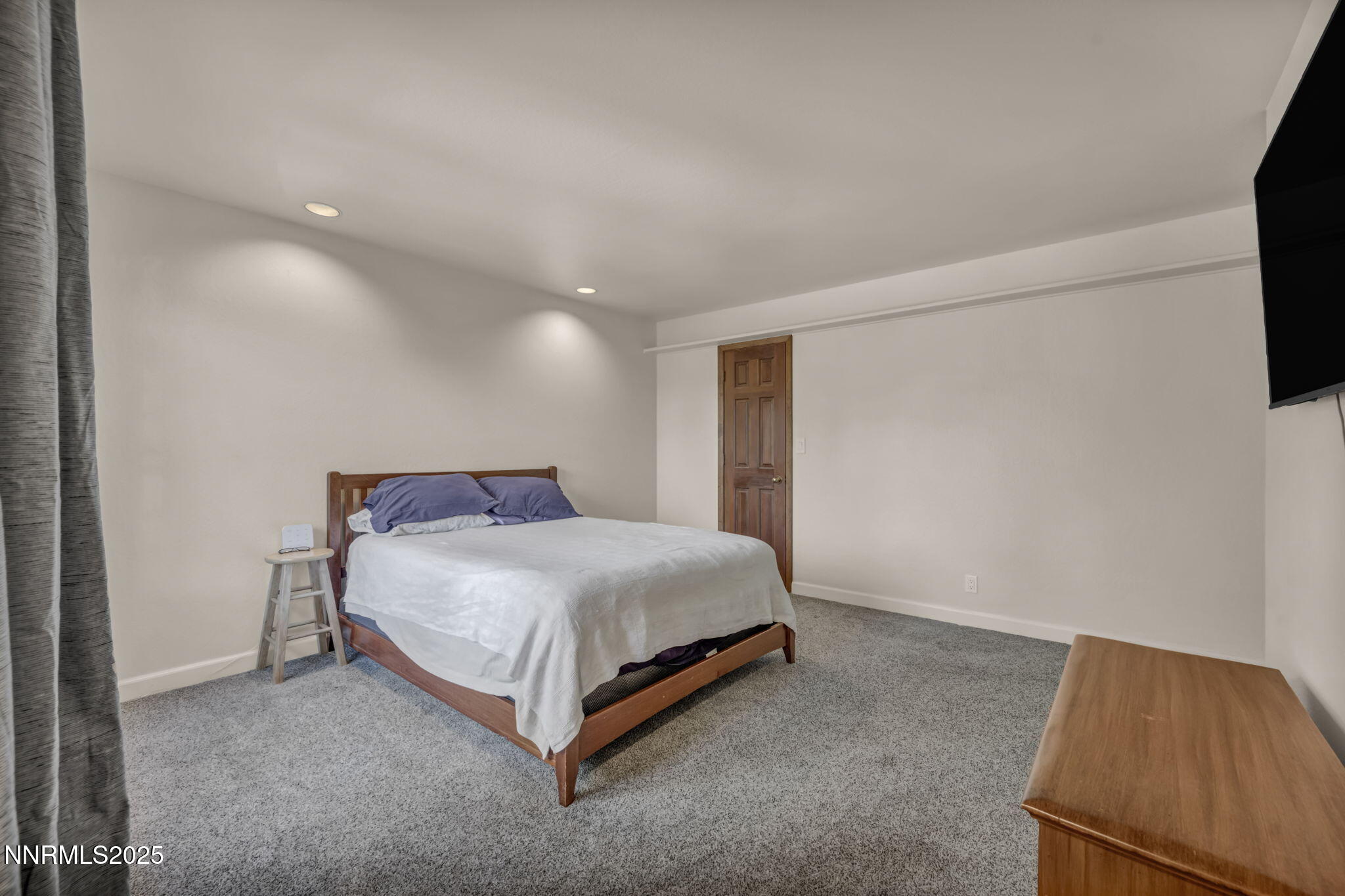 4283 Water Hole Road Reno, NV 89519 - Photo 34 of 62 a bed room with a bed and a television