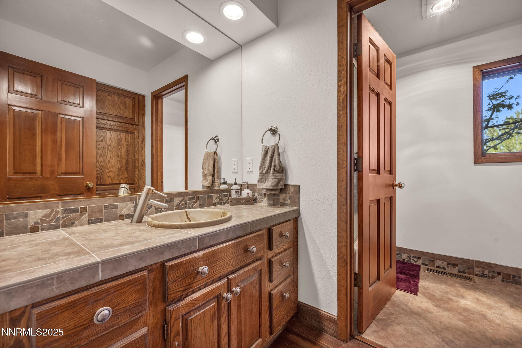 4283 Water Hole Road Reno, NV 89519 - Photo 35 of 62 a bathroom with a double vanity sink and a mirror