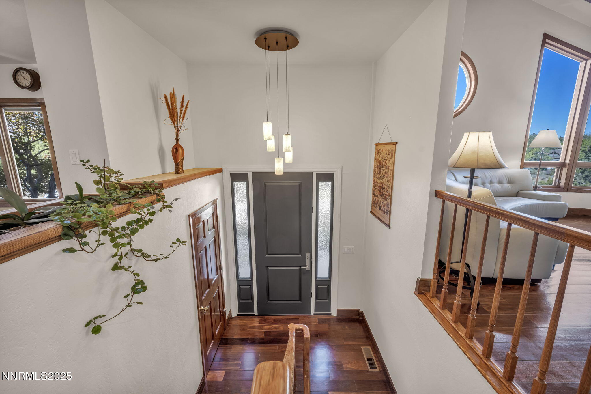 4283 Water Hole Road Reno, NV 89519 - Photo 4 of 62 a view of a hallway with wooden floor and staircase