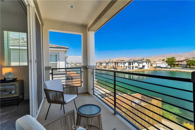 a view of a chairs and table in the balcony