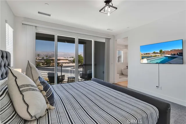 a bedroom with a bed a desk and chair