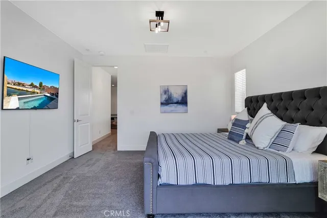 a bedroom with a bed and wall painting