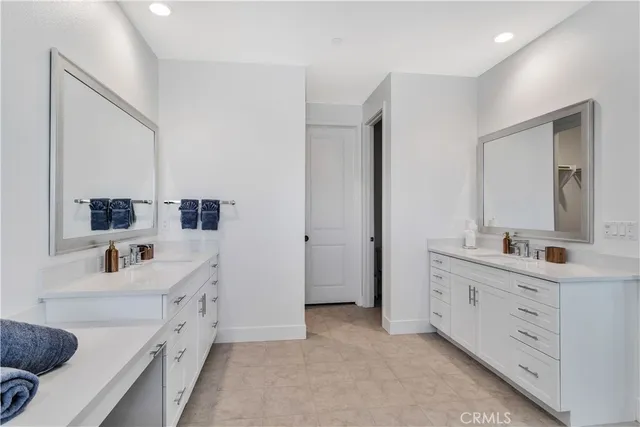 a bathroom with a double vanity sink and mirror