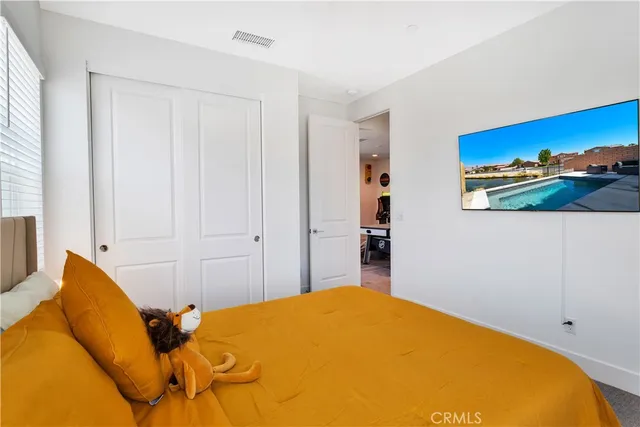a bedroom with a bed and a painting on the wall