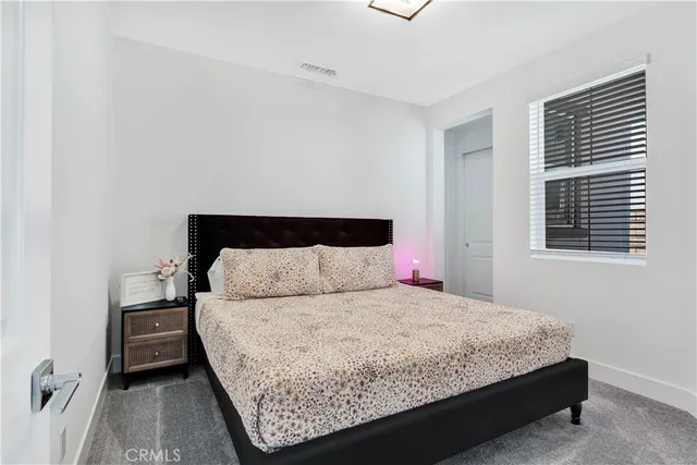 a bedroom with a bed and a night stand