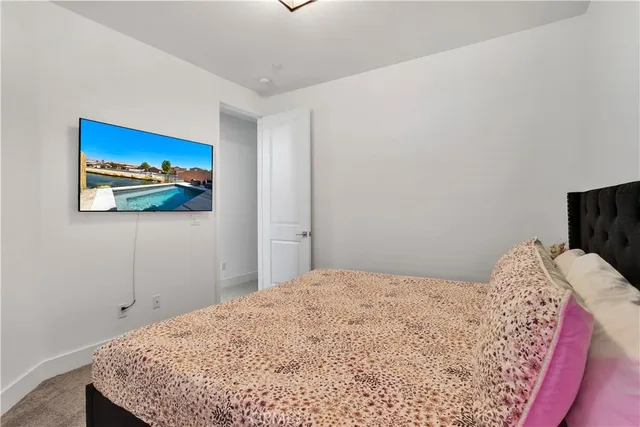 a bedroom with a bed and a wall painting