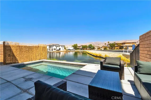 a view of a lake with couches chairs