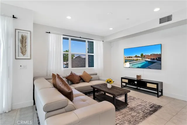 a living room with furniture a rug and a window