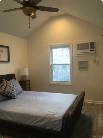 a bedroom with a bed and window