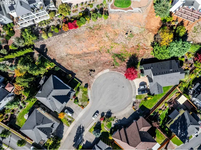 an aerial view of a house with swimming pool and outdoor seating