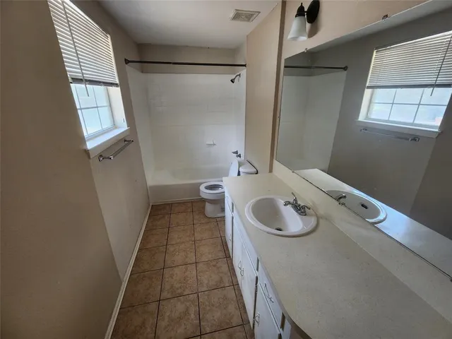 a bathroom with a shower a toilet and sink