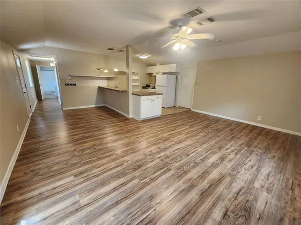 a view of a kitchen with a sink and microwave