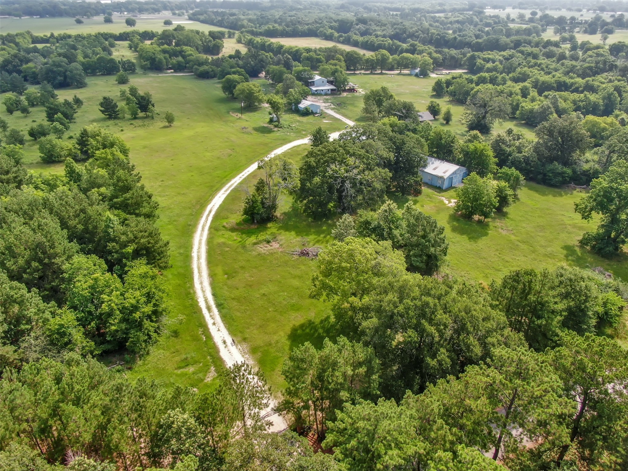 880 Tafelski Road New Waverly, TX 77358 - Photo 27 of 29 an aerial view of residential houses with outdoor space and trees