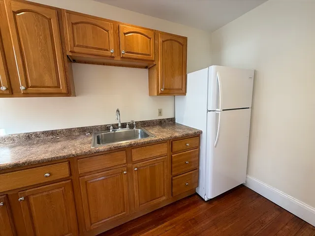 a kitchen with stainless steel appliances granite countertop a refrigerator sink and cabinets