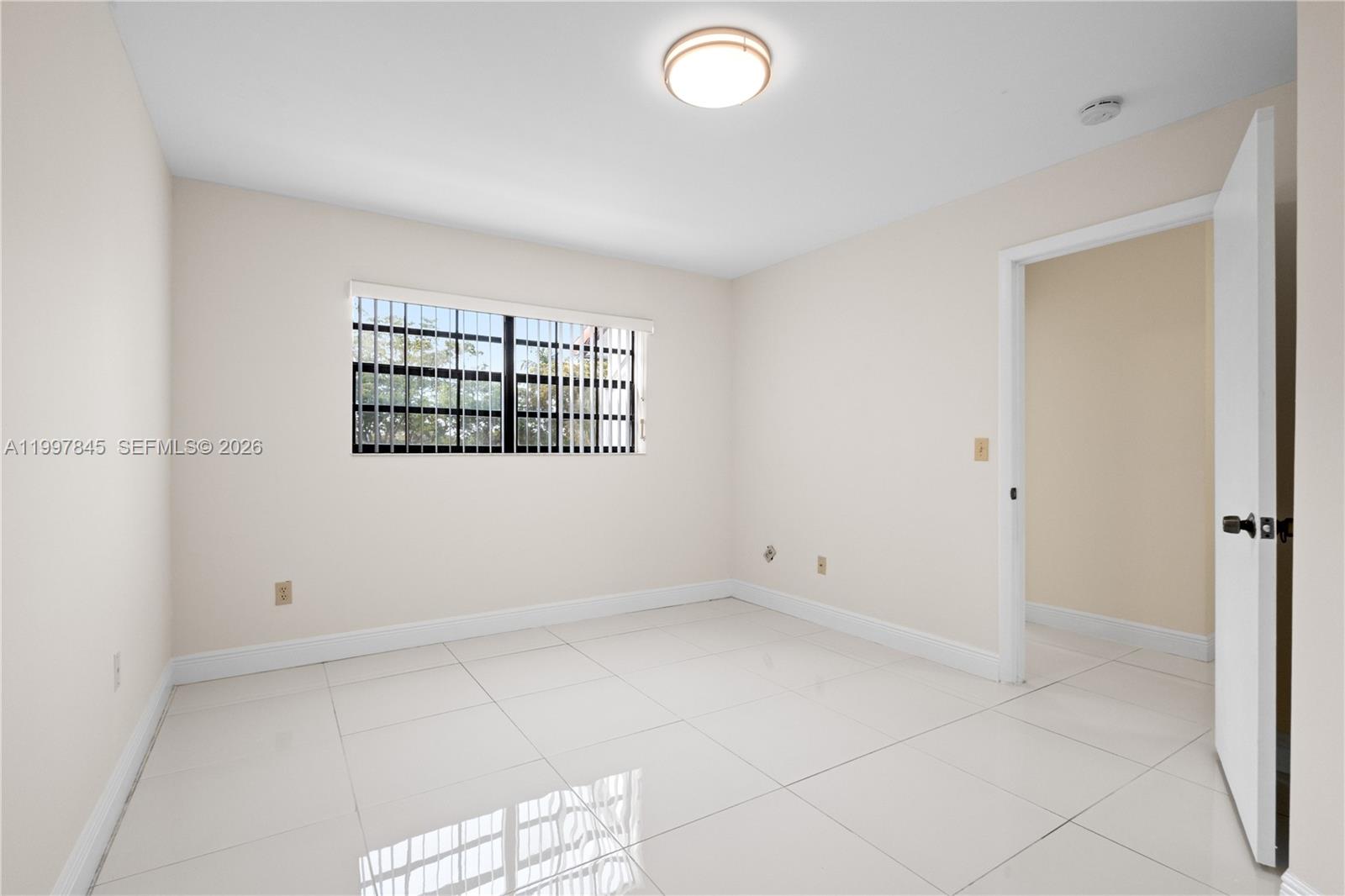 6211 Southwest 138th Court, Unit B Miami, FL 33183 - Photo 22 of 27 an empty room with windows